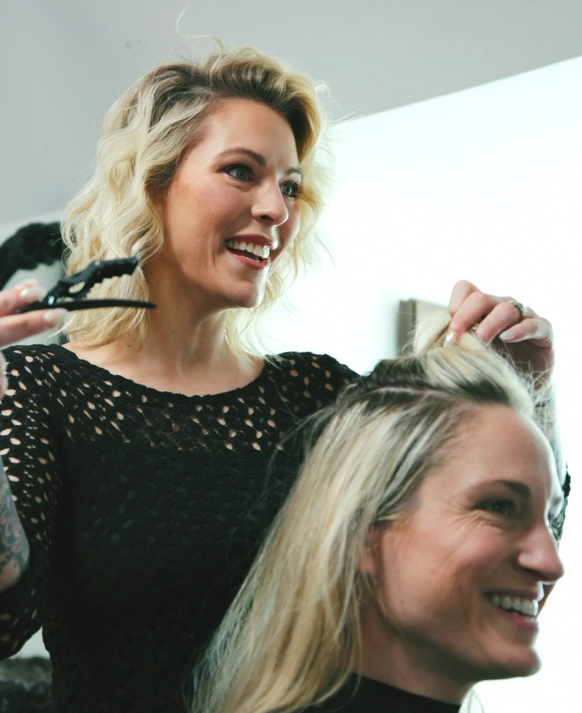 Lauren Jackson owner of Renata Salons cutting hair